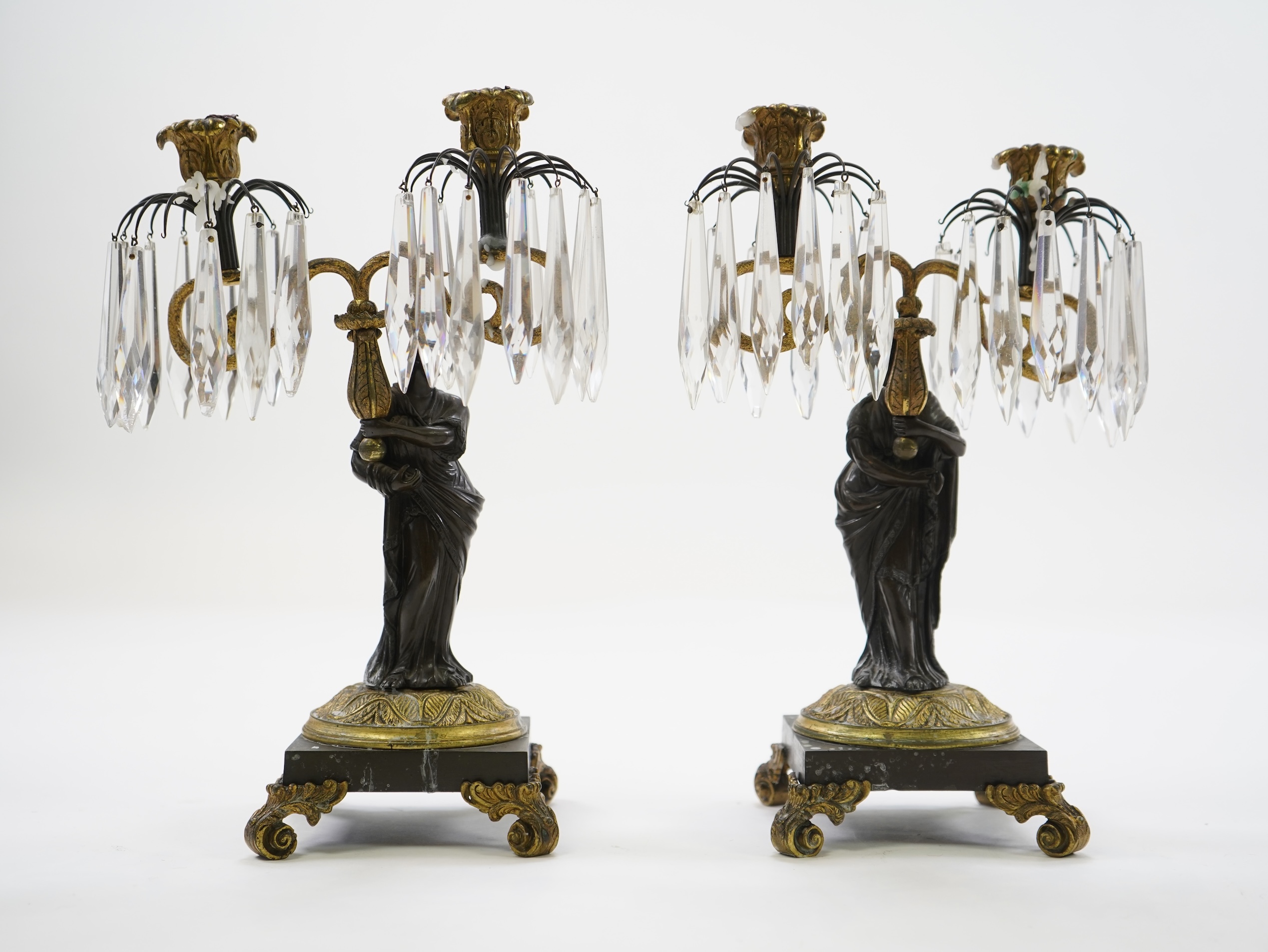 After Mathurin Moreau. A pair of mid 19th century bronze and gilt bronze two branch candelabra